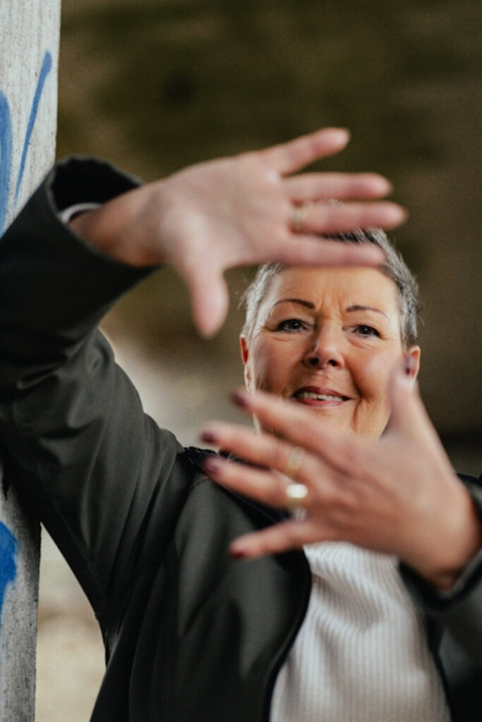 Frau hält die Hand vor ihr Gesicht